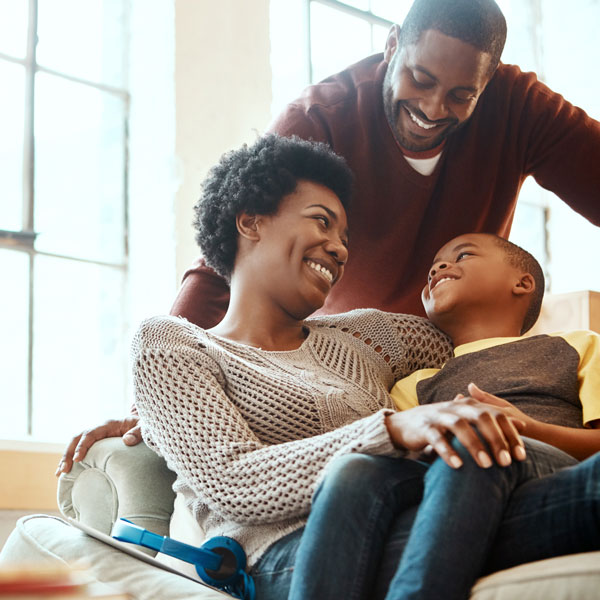 smiling family of three