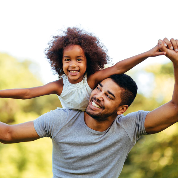 father with daughter on his back