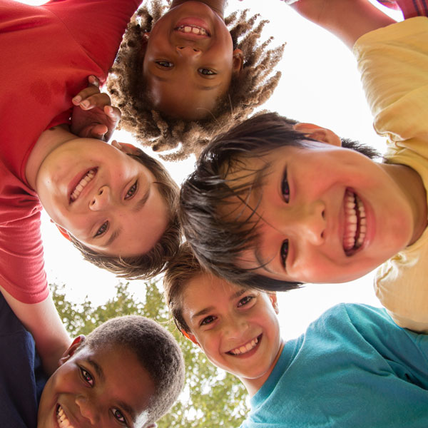 five kids smiling down at camera