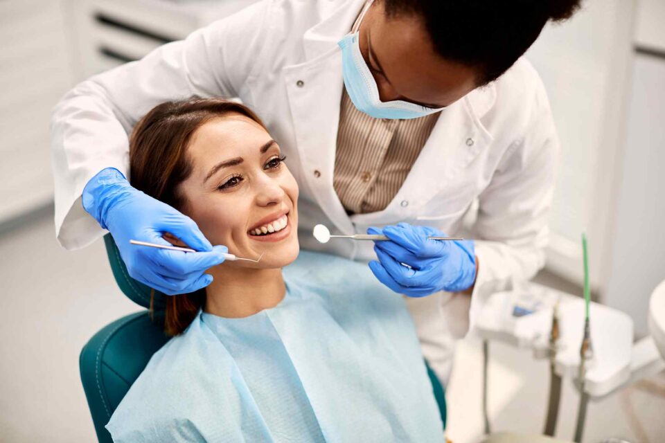 Dental exam with patient smiling during checkup at Creve Coeur Dental clinic in Creve Coeur, MO