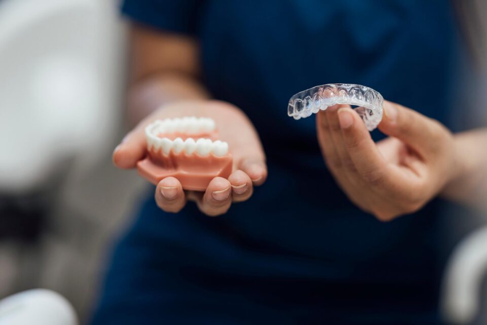Reliable Invisalign clear aligner held by a dental expert at Creve Coeur Dental in Creve Coeur, MO