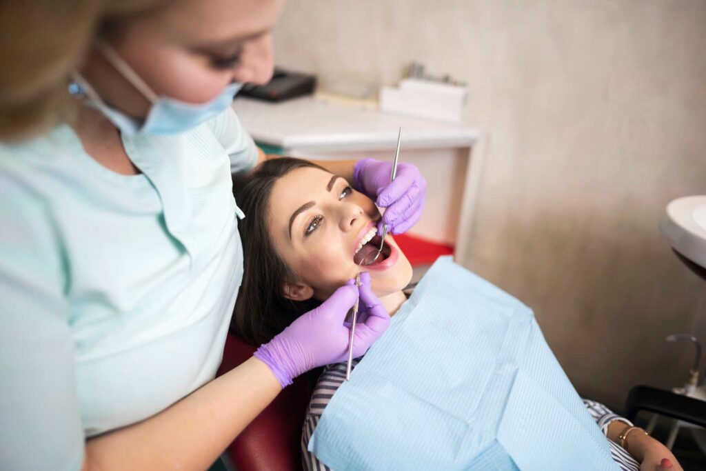 Dental professional examining a patient during a routine checkup at Creve Coeur Dental, MO